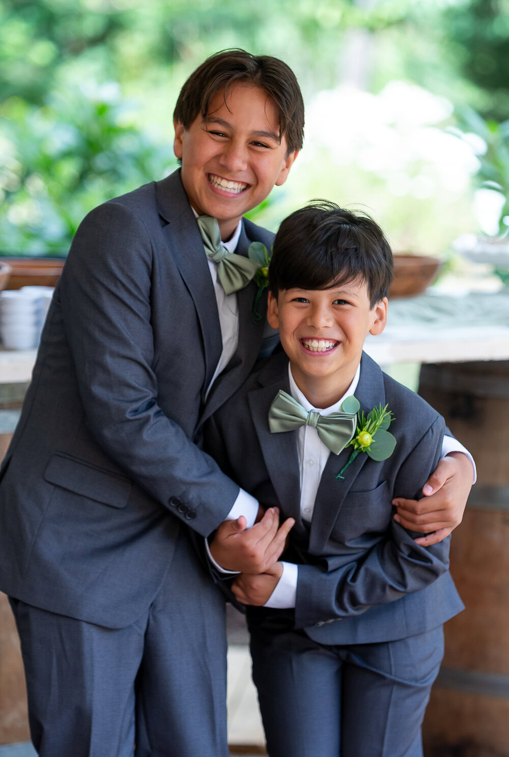 Happy boys in formal suits with bow ties at a wedding